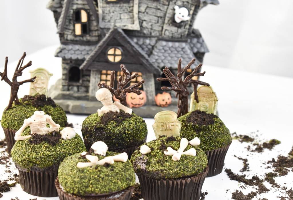 Graveyard themed cupcakes with chocolate dirt and skeleton decorations