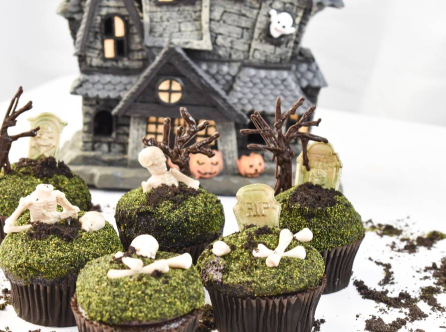 Graveyard themed cupcakes with chocolate dirt and skeleton decorations